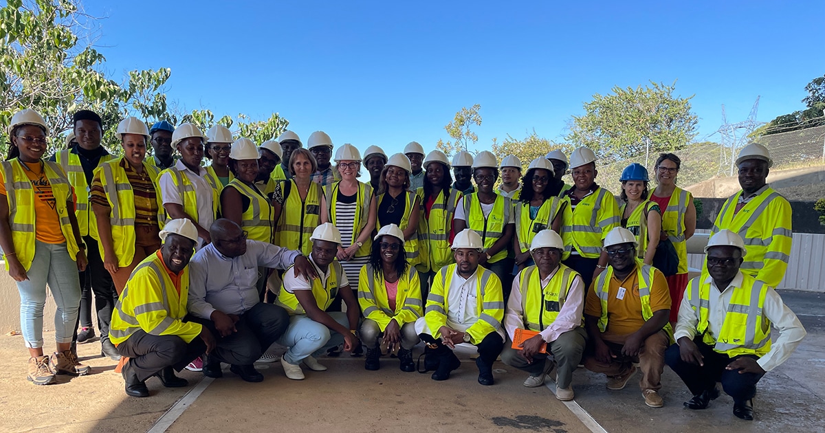 Group photo of programme participants with helmets and reflective vests.